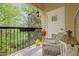 Cozy balcony view with mature trees and plants, seating area, and decorative lanterns, perfect for relaxation at 3636 Habersham Nw Rd # 2208, Atlanta, GA 30305