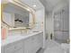 Bathroom featuring a glass door shower, marble countertop and decorative mirror at 3636 Habersham Nw Rd # 2208, Atlanta, GA 30305