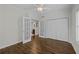 Bright bedroom featuring hardwood floors, ceiling fan and double doors opening to an adjoining bathroom at 3636 Habersham Nw Rd # 2208, Atlanta, GA 30305