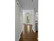 Hallway leads to open living space with hardwood floors and natural light at 3636 Habersham Nw Rd # 2208, Atlanta, GA 30305