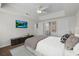 Main bedroom features a tray ceiling, mounted television and ensuite bathroom at 3636 Habersham Nw Rd # 2208, Atlanta, GA 30305