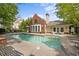 Community pool with a brick bathhouse, lounge chairs and a manicured lawn at 3636 Habersham Nw Rd # 2208, Atlanta, GA 30305