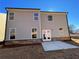 View of the backyard featuring gray siding, brick foundation and a concrete patio at 4300 Easter Lily Ave Lot 11, Buford, GA 30519