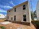 Exterior back view of a two-story home with siding, a patio, and a brick foundation at 4300 Easter Lily Ave Lot 11, Buford, GA 30519