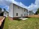 Exterior back view of a new two-story home with white siding and a newly seeded backyard at 4300 Easter Lily Ave Lot 11, Buford, GA 30519
