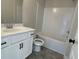 Bathroom with modern vanity, toilet, and subway-tiled shower/bathtub combo at 4300 Easter Lily Ave Lot 11, Buford, GA 30519