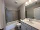 Well-lit bathroom features a shower-tub combo, modern fixtures, and updated vanity at 4300 Easter Lily Ave Lot 11, Buford, GA 30519