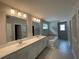 Luxurious bathroom with double sinks, vanity, and a separate tub for a spa-like experience at 4300 Easter Lily Ave Lot 11, Buford, GA 30519