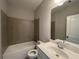 Cozy bathroom with a tile-surround bathtub and a bright white vanity with a framed mirror at 4300 Easter Lily Ave Lot 11, Buford, GA 30519