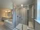 Elegant bathroom with a glass-enclosed shower, separate tub, and double vanity with bright lighting at 4300 Easter Lily Ave Lot 11, Buford, GA 30519