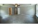 Spacious bedroom featuring plush carpeting, a ceiling fan, and ample natural light from a large window at 4300 Easter Lily Ave Lot 11, Buford, GA 30519