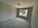 Sunlit bedroom features plush carpeting, ample natural light from windows, and neutral decor at 4300 Easter Lily Ave Lot 11, Buford, GA 30519