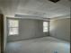 Spacious bedroom with tray ceiling and large windows overlooking backyard at 4300 Easter Lily Ave Lot 11, Buford, GA 30519
