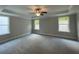 Bright, carpeted bedroom featuring recessed lighting, a ceiling fan and multiple windows for ample natural light at 4300 Easter Lily Ave Lot 11, Buford, GA 30519