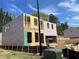 New home under construction shows frame, weatherproofing, and attached two-car garage at 4300 Easter Lily Ave Lot 11, Buford, GA 30519