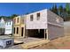 New construction home showing framing, weatherproofing, and a two-car garage at 4300 Easter Lily Ave Lot 11, Buford, GA 30519