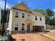 New two story home featuring large windows and an open garage in a construction phase at 4300 Easter Lily Ave Lot 11, Buford, GA 30519