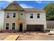 New two story home featuring large windows and an open garage in a construction phase at 4300 Easter Lily Ave Lot 11, Buford, GA 30519