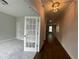 Interior view of a hallway showcasing hardwood floors, neutral paint, and a glimpse into an adjacent room at 4300 Easter Lily Ave Lot 11, Buford, GA 30519