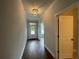 Bright hallway showcasing hardwood floors, crown molding, and an open doorway leading to another room at 4300 Easter Lily Ave Lot 11, Buford, GA 30519