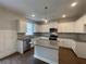 Modern kitchen boasts granite countertops, stainless steel appliances, and a stylish central island at 4300 Easter Lily Ave Lot 11, Buford, GA 30519