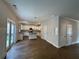 Open-concept kitchen and dining area with hardwood floors, white cabinets, and stainless steel appliances at 4300 Easter Lily Ave Lot 11, Buford, GA 30519