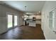 Bright kitchen with white cabinets, hardwood floors, stainless steel appliances, and a view to the outdoors at 4300 Easter Lily Ave Lot 11, Buford, GA 30519