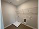 The laundry room includes convenient shelf storage and modern hookups for appliances at 4300 Easter Lily Ave Lot 11, Buford, GA 30519