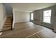 Spacious living room with unfinished staircase and new windows, ready to be completed at 4300 Easter Lily Ave Lot 11, Buford, GA 30519