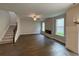 Bright living room featuring hardwood floors, modern fireplace, staircase, and large windows with natural light at 4300 Easter Lily Ave Lot 11, Buford, GA 30519