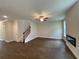 Spacious living room with hardwood floors, a modern fireplace, and a ceiling fan for added comfort at 4300 Easter Lily Ave Lot 11, Buford, GA 30519