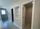 En suite bathroom boasts a tiled floor, built-in shelves, and a spacious walk-in closet at 4300 Easter Lily Ave Lot 11, Buford, GA 30519