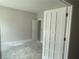 Unfurnished room with gray walls and a light-filled interior view through a set of french doors at 4300 Easter Lily Ave Lot 11, Buford, GA 30519