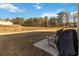 A backyard patio with comfortable chairs, with view of treeline in the distance at 891 Feldman Chase, Loganville, GA 30052