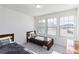 Bright bedroom with two twin beds, a large window, and a shared nightstand at 891 Feldman Chase, Loganville, GA 30052