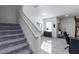View of the stairs and entryway. The entry features neutral walls and stylish decor at 891 Feldman Chase, Loganville, GA 30052