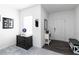 Bright entryway featuring neutral walls, dark wood floors, and stylish furnishings at 891 Feldman Chase, Loganville, GA 30052