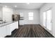 Eat-in kitchen area featuring wood floors, stainless steel appliances, and sliding glass doors to backyard at 891 Feldman Chase, Loganville, GA 30052
