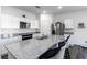 Kitchen with stainless appliances, white cabinets, and granite countertop island with barstool seating at 891 Feldman Chase, Loganville, GA 30052