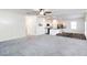 Open-concept living room and kitchen featuring modern appliances, white cabinets, and a ceiling fan at 891 Feldman Chase, Loganville, GA 30052