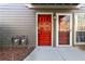 Inviting condo entrance featuring a vibrant red door, exterior lighting, and a welcoming pathway at 2006 Riverview Dr, Marietta, GA 30067