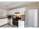 Bright kitchen showcasing stainless steel refrigerator, white cabinets and sleek black oven at 2006 Riverview Dr, Marietta, GA 30067