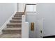 Carpeted staircase ascends with white railings, showcasing a modern design and natural light at 2006 Riverview Dr, Marietta, GA 30067