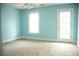 Bright bedroom features carpet, a window, and a door to the outside at 3348 Summit Turf Ln, Snellville, GA 30078