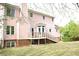 Back exterior view of home with a deck, backyard, and brick foundation at 3348 Summit Turf Ln, Snellville, GA 30078