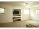 Bright living room with carpet, a built-in TV nook, and ample natural light at 3348 Summit Turf Ln, Snellville, GA 30078