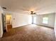 Spacious living room with neutral carpet, ceiling fan, natural light, and seamless flow to adjacent rooms at 3348 Summit Turf Ln, Snellville, GA 30078