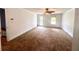 Large living room with neutral carpet, ceiling fan, and natural light is perfect for entertaining at 3348 Summit Turf Ln, Snellville, GA 30078