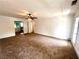 Expansive living room with neutral carpet, ceiling fan, and natural light pouring in through french doors at 3348 Summit Turf Ln, Snellville, GA 30078