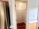 Walk-in pantry with white wire shelving and hardwood floors is conveniently located next to the kitchen refrigerator at 3348 Summit Turf Ln, Snellville, GA 30078